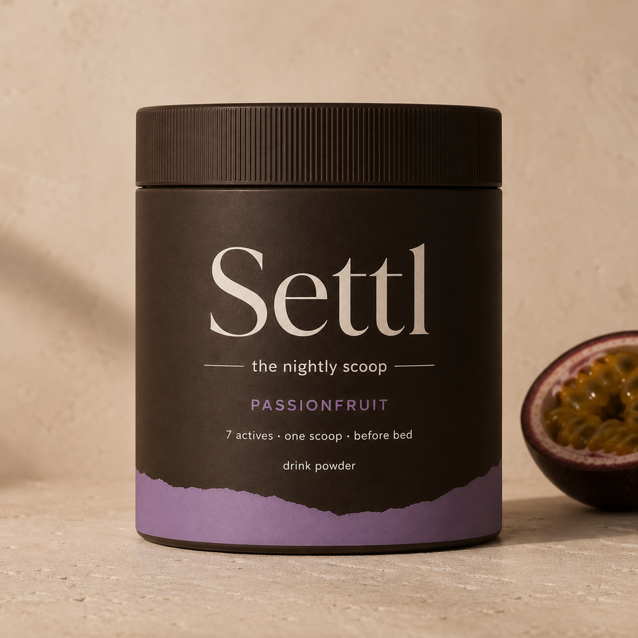 Settl tub beside a halved passionfruit on warm stone.